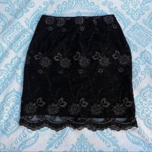 Black laced-style skirt with floral-like details